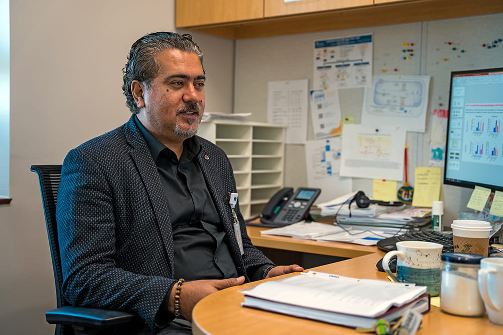 a scientist sits at his desk surrounded by notes 